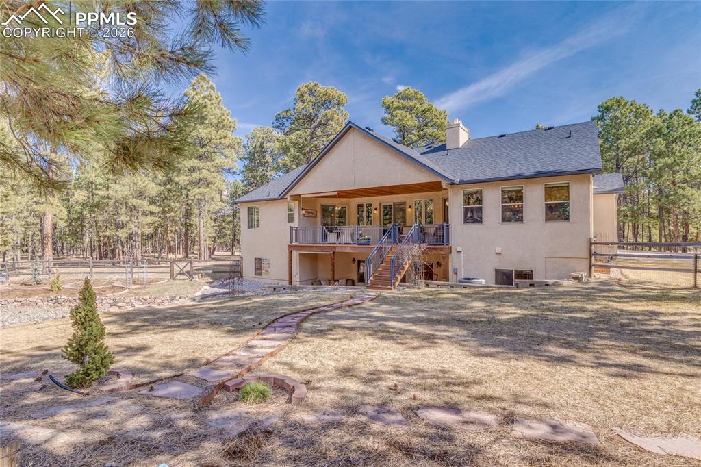 Image 24 of 50: Beautifully landscaped fenced backyard.