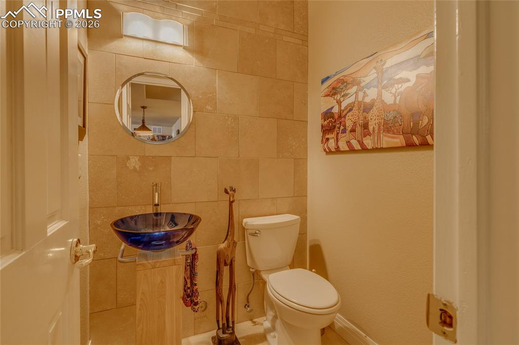 Image 33 of 50: Custom half-bath in basement.