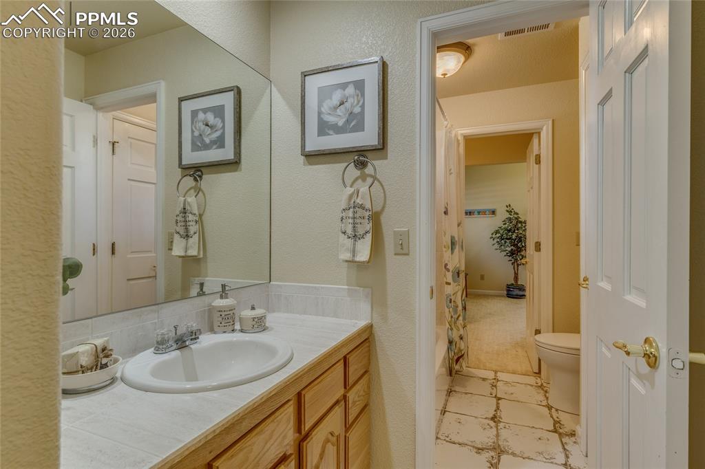 Image 36 of 50: Connecting bathroom and shared shower and toilet area.