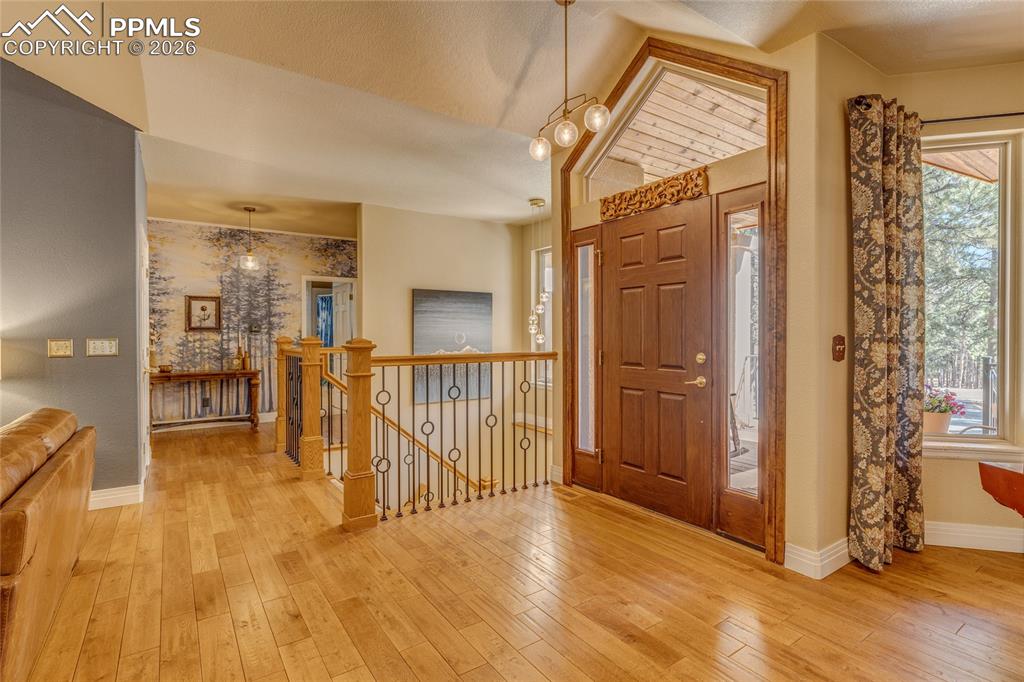 Image 5 of 50: Front entrance looking at the beautiful staircase leading to the basement a