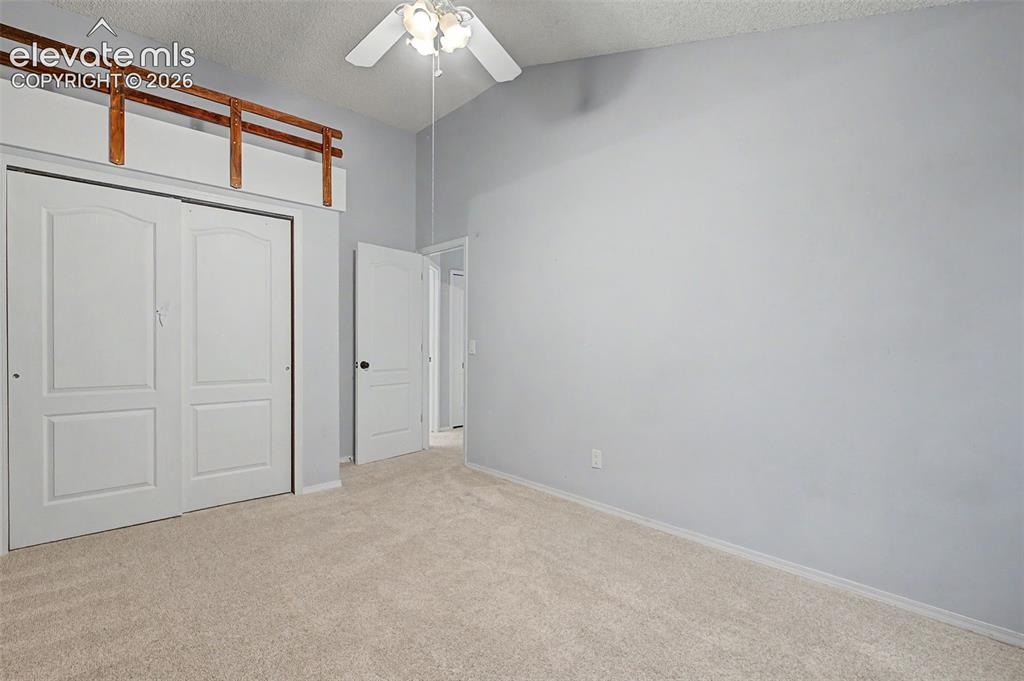 Image 26 of 42: Carpeted interior space featuring a ceiling fan with integrated lighting, t