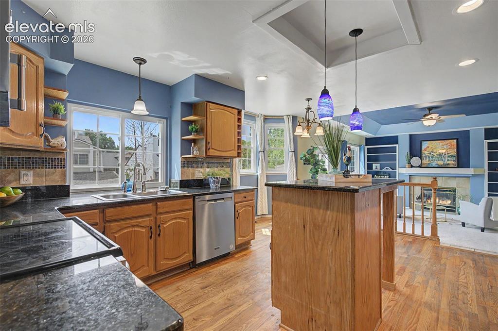 Image 8 of 42: Kitchen featuring granite countertops, wood cabinetry, stainless steel dish