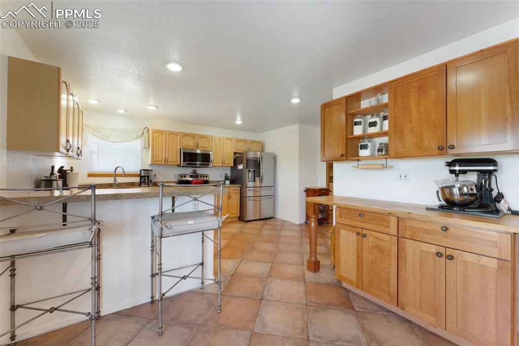 Image 10 of 44: Open Kitchen Includes Large Pantry, Breakfast Bar, Plenty of Countertop & C