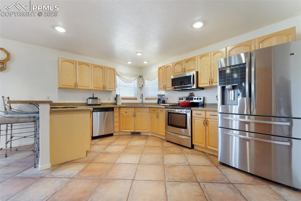 Image 13 of 44: Open Kitchen Includes Large Pantry, Breakfast Bar, Plenty of Countertop & C