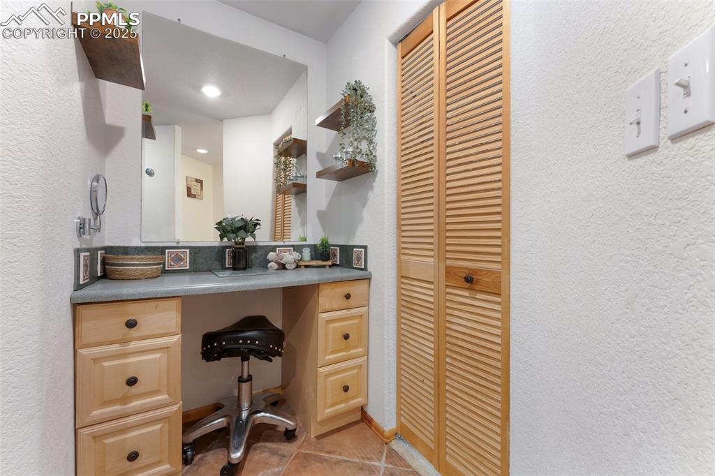 Image 21 of 44: Third Vanity Space Between Two Large Walk-In Closets