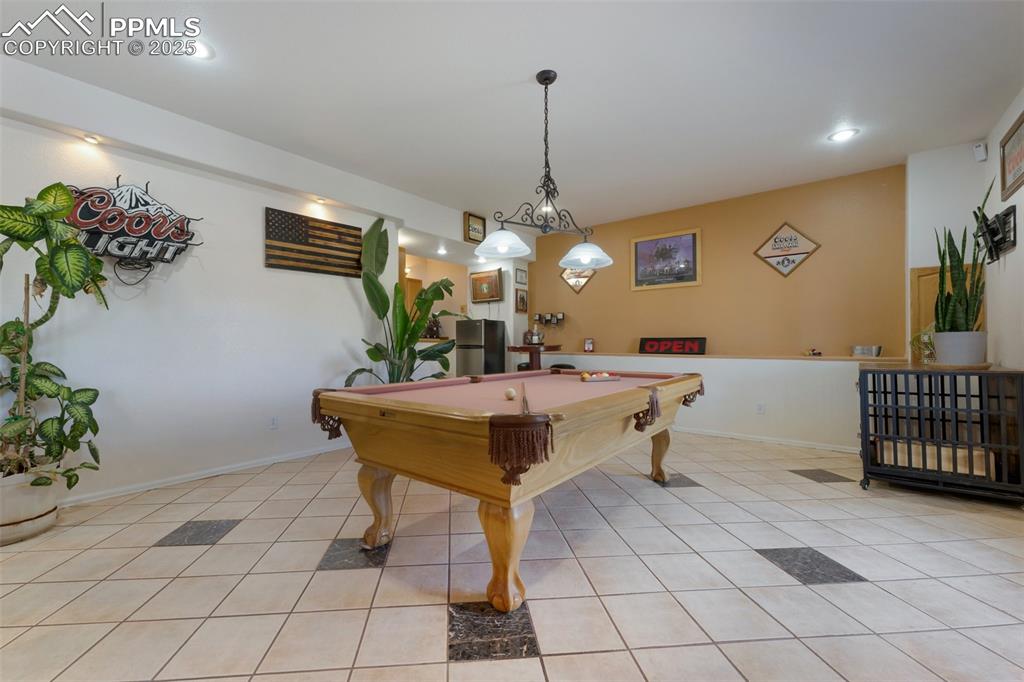 Image 33 of 44: Basement Level Game Room with Dry-bar and Walkout to Concrete Patio; Perfec