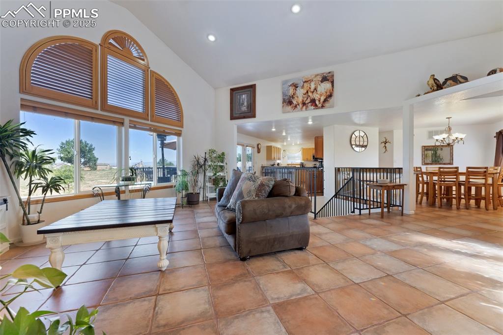 Image 6 of 44: Bright and Open Main Level Living Room with Soaring Vaulted Ceiling and Exq