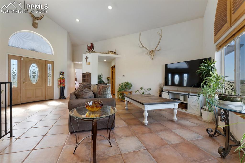 Image 7 of 44: Bright and Open Main Level Living Room with Soaring Vaulted Ceiling and Exq