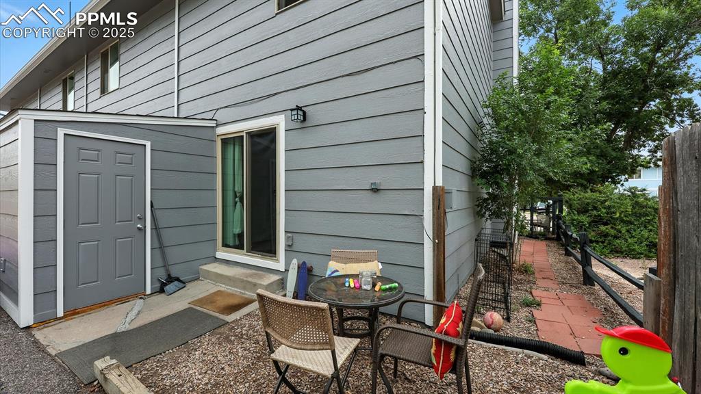 Image 12 of 29: Backyard storage unit and gravel patio area for outdoor BBQs and relaxation