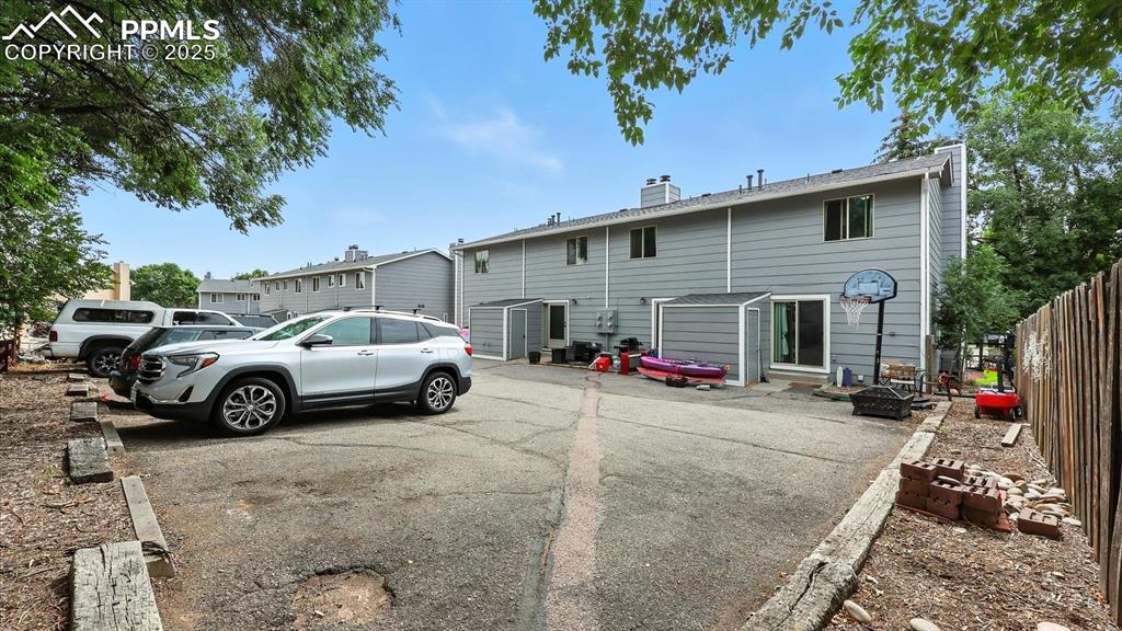 Image 22 of 29: Rear view of home with 2 assigned parking spaces.