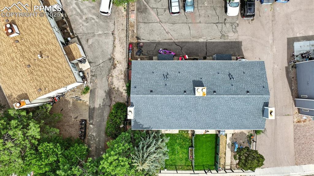 Image 29 of 29: Aerial view of the front yard and backyard parking area.