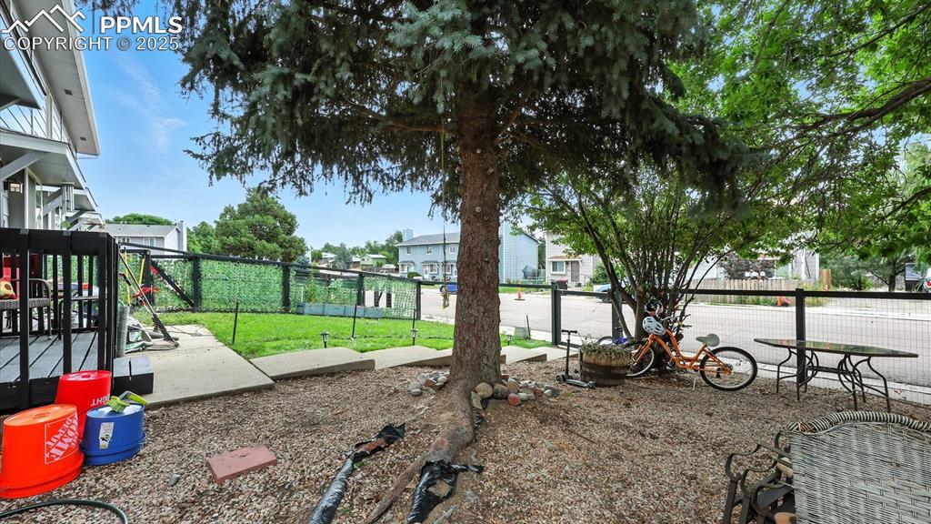 Image 4 of 29: Low maintenance landscaping and private yard for the kids and pets to play.