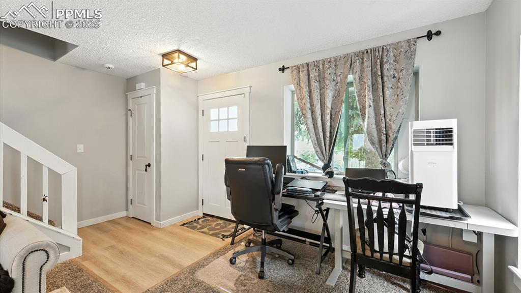 Image 5 of 29: Wood laminate Entry with coat closet that leads into the Living Room.
