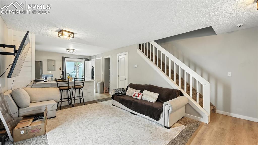 Image 8 of 29: Living Room with stairs to the upper level.