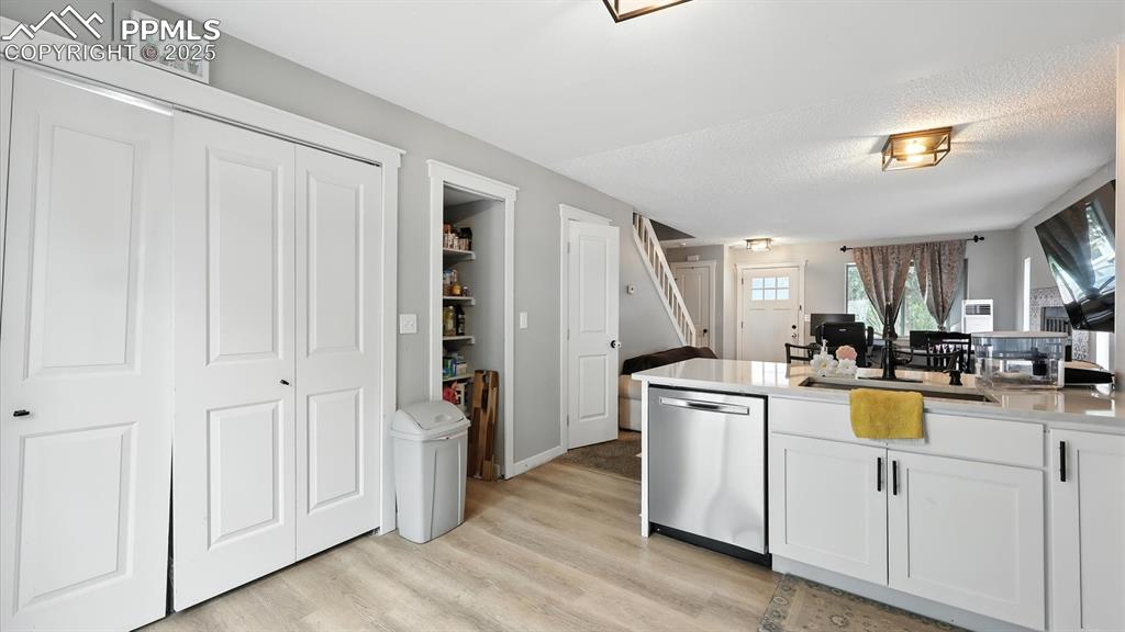 Image 9 of 29: Kitchen with pantry and laundry closet with electrical hookup.