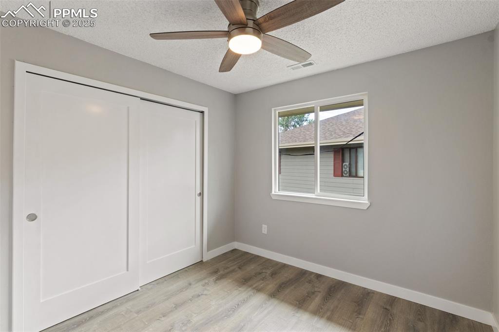 Image 10 of 15: Bedroom with ceiling fan