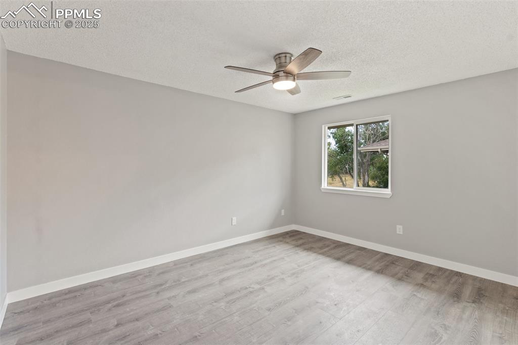 Image 11 of 15: Bedroom with ceiling fan