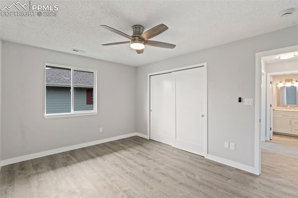 Image 12 of 15: Bedroom with ceiling fan