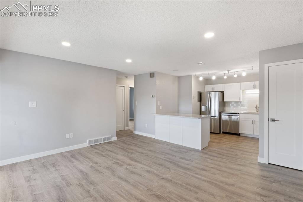 Image 5 of 15: Living room toward kitchen (2)