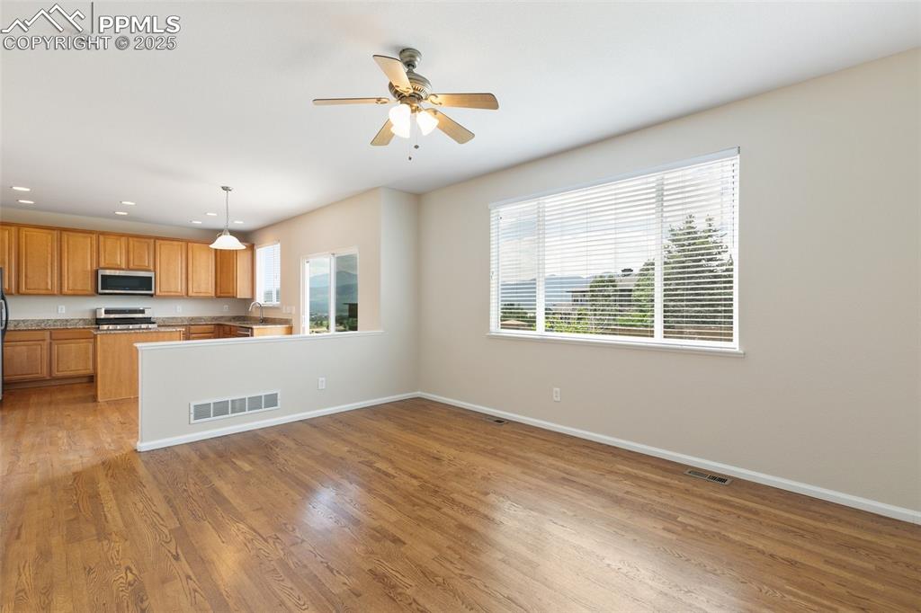Image 11 of 45: Kitchen featuring appliances with stainless steel finishes, plenty of natur