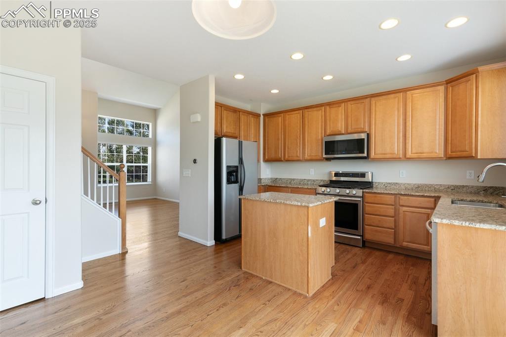 Image 12 of 45: Kitchen featuring stainless steel appliances, a center island, recessed lig