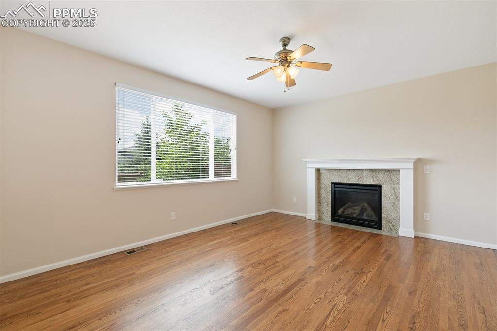 Image 13 of 45: Unfurnished living room featuring ceiling fan, light wood finished floors,