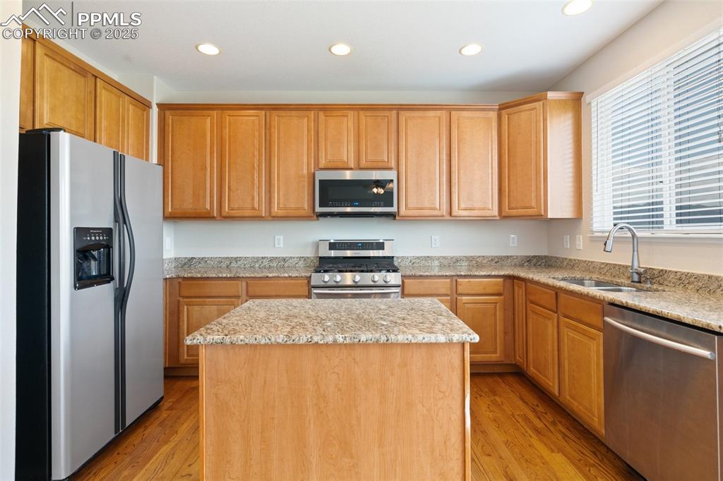 Image 17 of 45: Kitchen featuring stainless steel appliances, recessed lighting, a center i