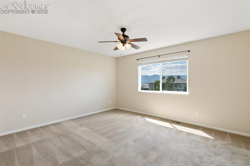 Image 23 of 45: Carpeted empty room with ceiling fan and baseboards