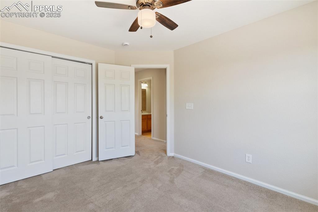 Image 28 of 45: Unfurnished bedroom with light carpet, a closet, and ceiling fan