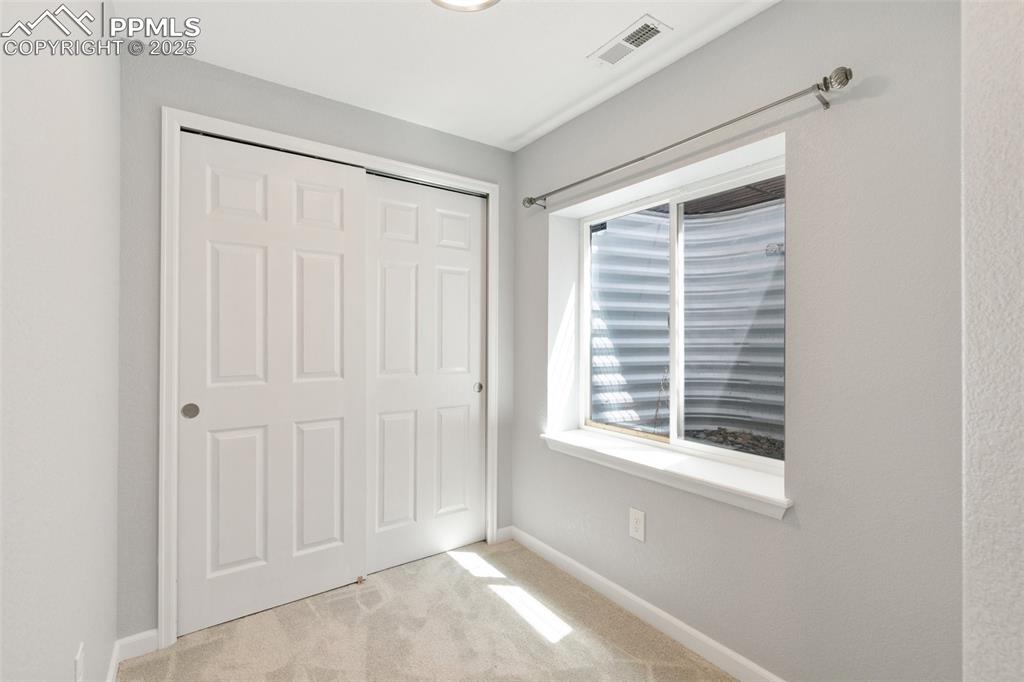 Image 40 of 45: Unfurnished bedroom with carpet flooring and a closet