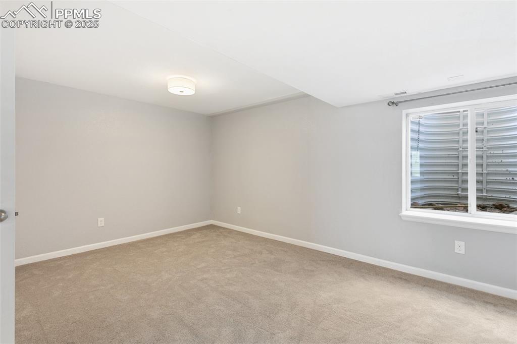 Image 41 of 45: Empty room featuring carpet and baseboards