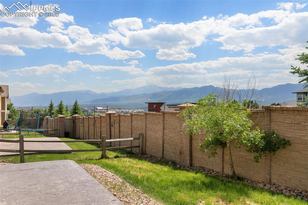 Image 43 of 45: View of yard featuring a trampoline and a mountain view