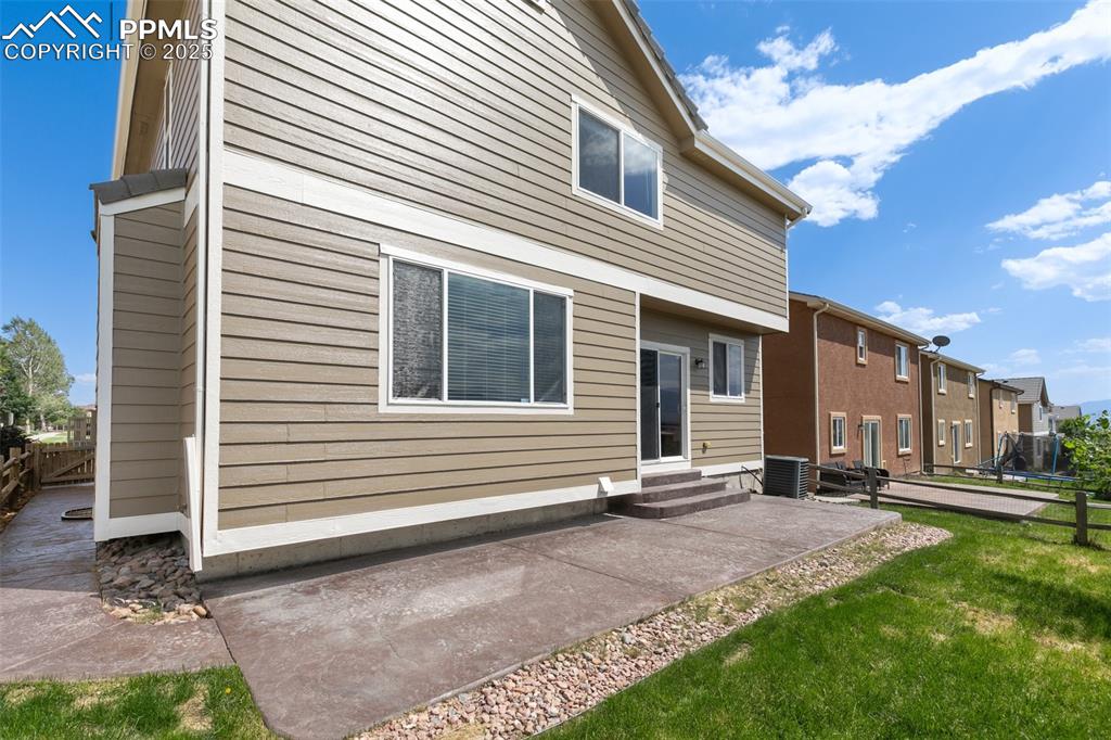Image 45 of 45: Rear view of property with entry steps, a patio area, and a residential vie
