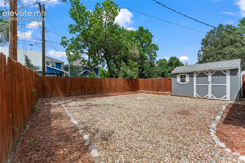 Image 16 of 22: Storage shed in back yard
