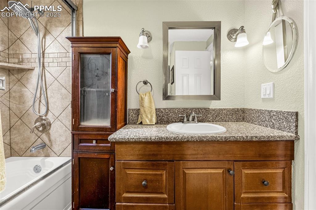Image 14 of 31: Full bathroom with vanity and tub / shower combination