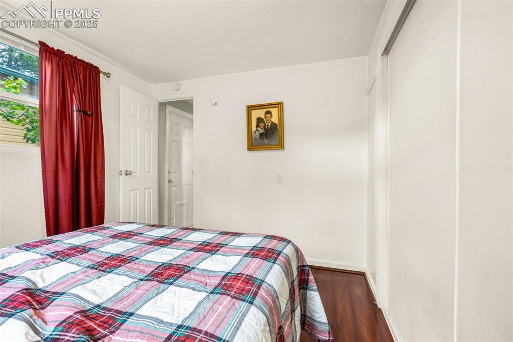 Image 16 of 31: Bedroom with wood finished floors and baseboards