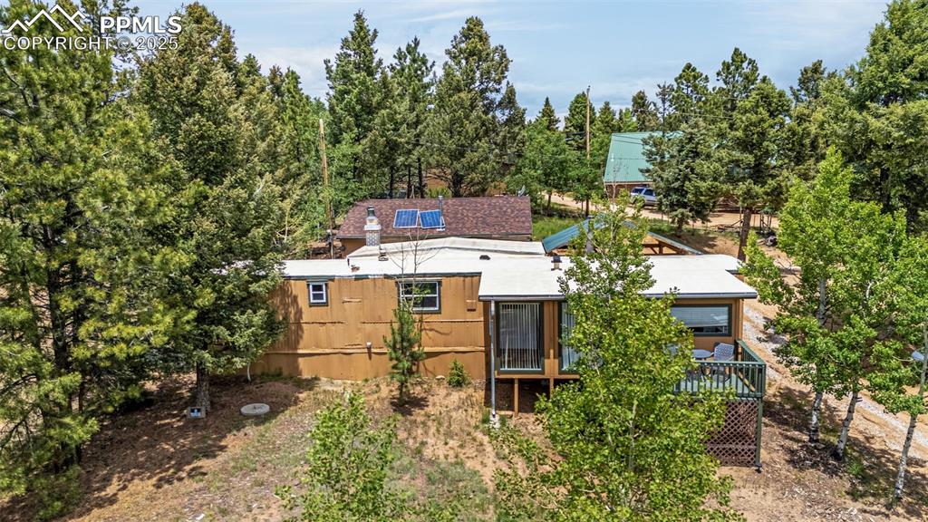 Image 18 of 31: Rear view of house with a wooden deck
