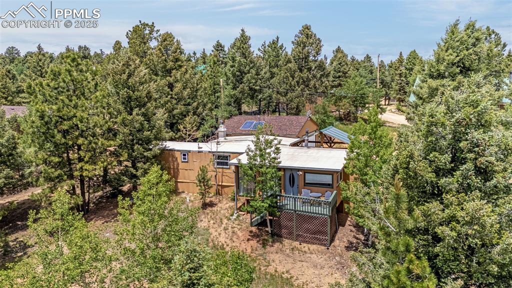 Image 19 of 31: Aerial view of property and surrounding area featuring a forest
