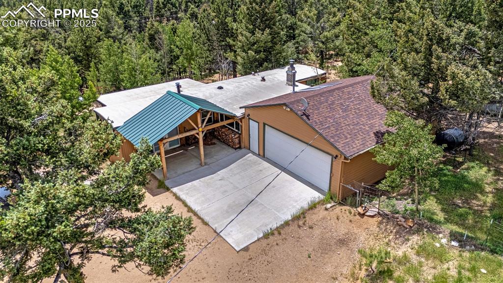 Image 20 of 31: View from above of property featuring a heavily wooded area