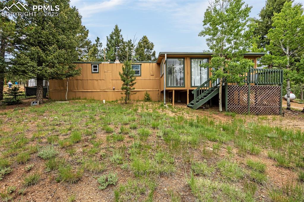 Image 28 of 31: View of yard with stairs and a wooden deck