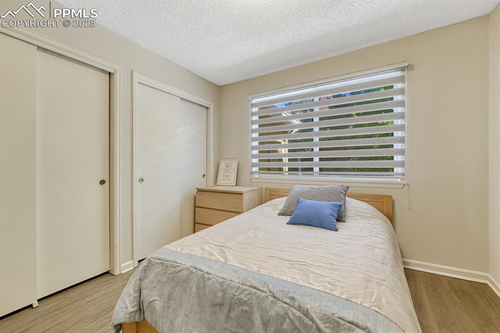 Image 15 of 31: Living area featuring light wood-type flooring, healthy amount of natural l