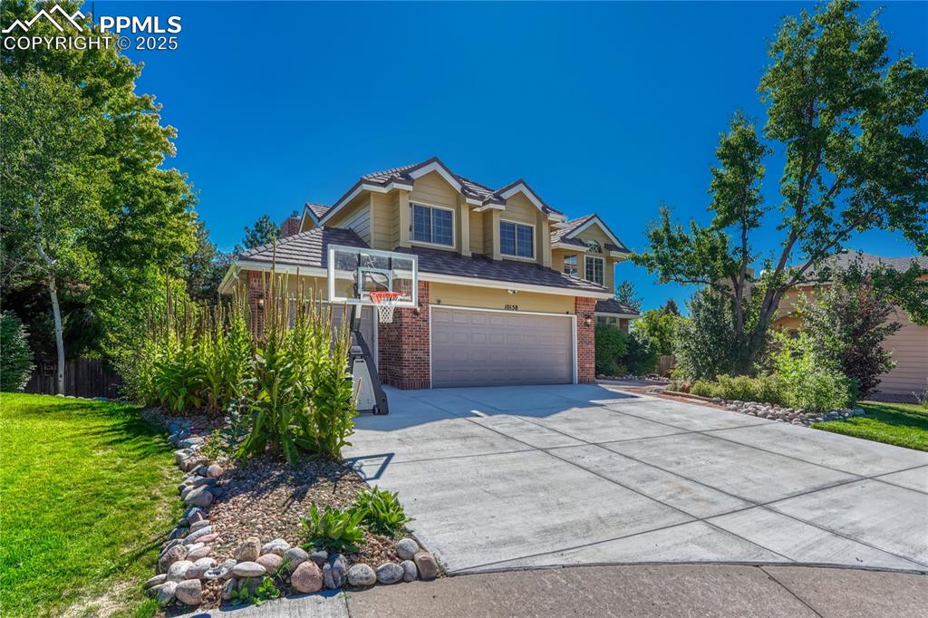 Image 2 of 31: View of front of house featuring brick siding, concrete driveway, a garage,