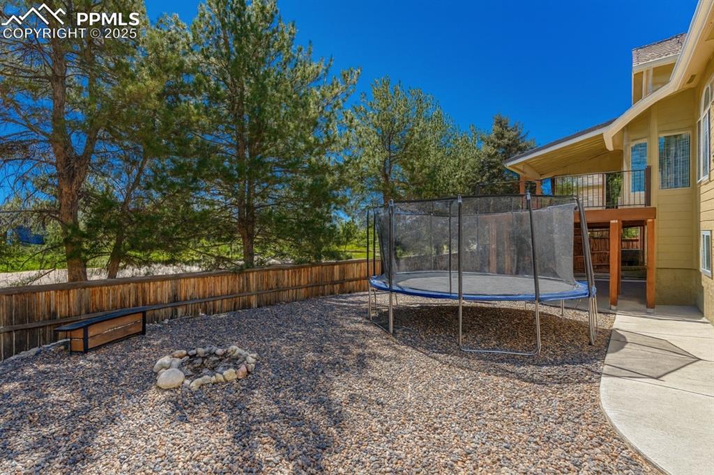 Image 26 of 31: Fenced backyard featuring a patio area and stairs