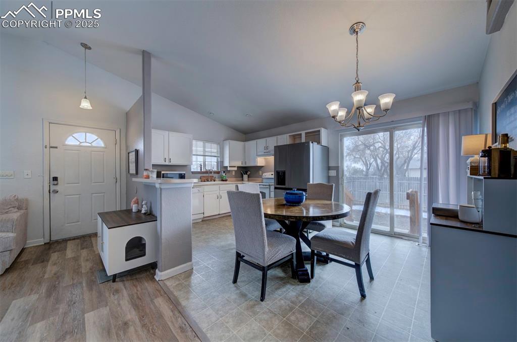 Image 12 of 25: Dining area featuring light wood-style flooring, an inviting chandelier, an