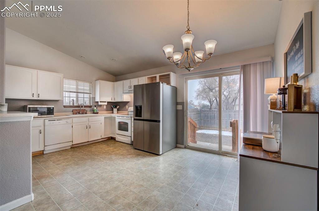 Image 15 of 25: Kitchen featuring light countertops, appliances with stainless steel finish