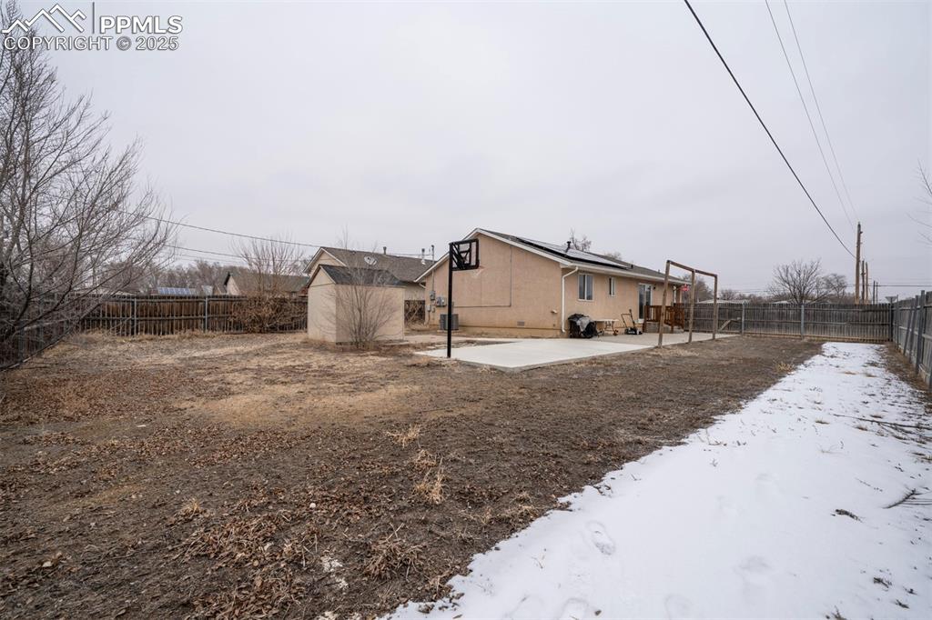 Image 5 of 25: View of yard featuring a patio, an outdoor structure, a fenced backyard, an