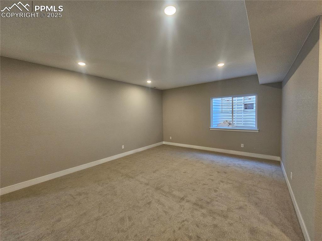 Image 10 of 12: Empty room featuring light colored carpet and recessed lighting