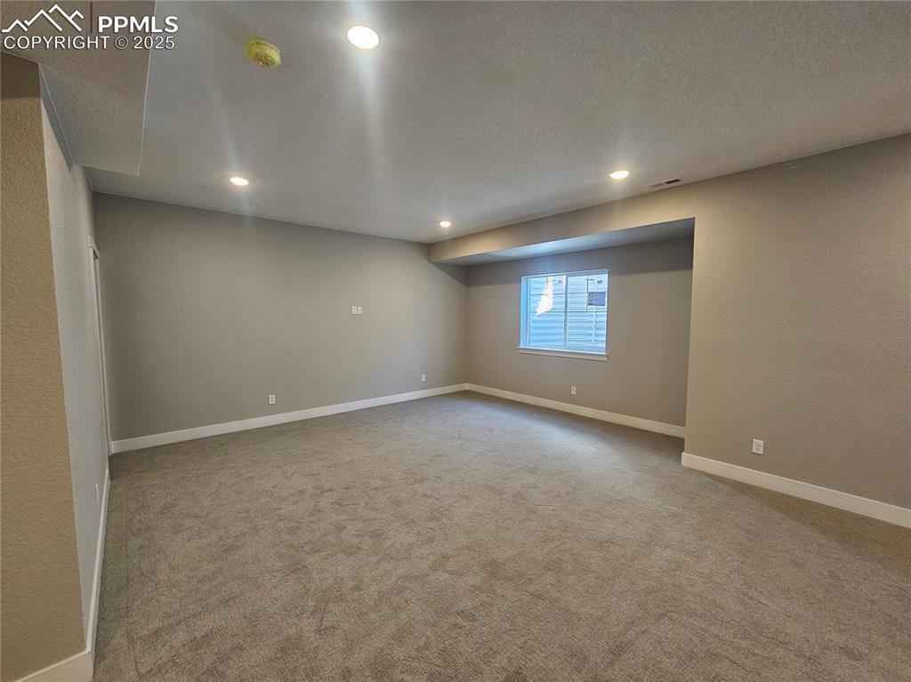 Image 11 of 12: Unfurnished room with light carpet, recessed lighting, a textured wall, a t