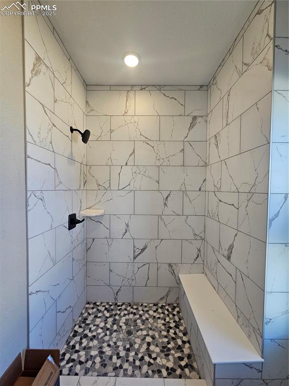 Image 7 of 12: Bathroom featuring tiled shower