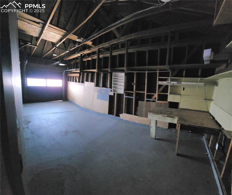 Image 25 of 25: extra long garage with workshop area